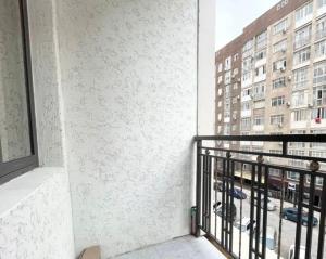 a balcony with a view of a building at 1bdr apartment Asanbay in Bishkek