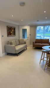 a living room with a couch and a table at Derry City Apartment in Derry Londonderry