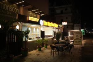 a restaurant with tables and chairs outside at night at Virasat Vistar Gateway in Lucknow