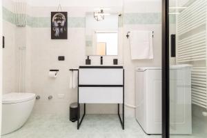 a white bathroom with a sink and a toilet at Casa Mary 2 - 80 mt dal mare - centro storico in Varazze +16 photos