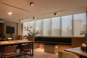 a conference room with a table and chairs at Marina Retreat Stylish One Bedroom by Hala Homes in Ras al Khaimah