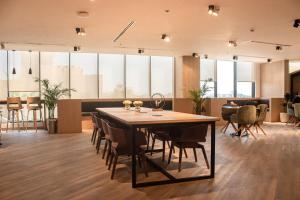 a large dining room with a table and chairs at Marina Retreat Stylish One Bedroom by Hala Homes in Ras al Khaimah