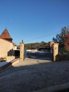 a gate to a house with a driveway at Villa Les Combes avec piscine chauffée in Proissans