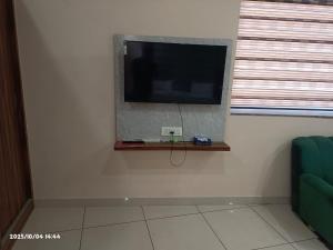 a flat screen tv on a wall in a room at Hotel Rohan International in Jāmb