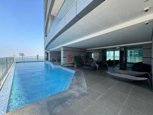 einem großen Pool an der Seite eines Gebäudes in der Unterkunft Modern comfort in a compact spacious studio one or two bedroom retreats in Manama