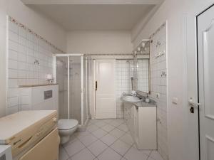 a white bathroom with a toilet and a sink at Villa Atenea by Aura Villas in Charco del Palo +25 photos