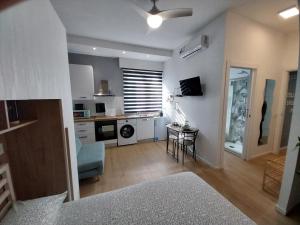 a living room with a kitchen and a dining room at Litte Sweet Home - Abbiategrasso città in Abbiategrasso
