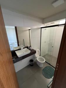 a bathroom with a sink and a toilet at Loft Bell Valle in Sorriso