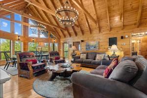 a living room with a couch and a table at Mountain Laurel Lodge by American Patriot Getaways in Caton