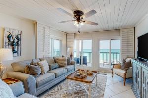 a living room with a couch and a television at Pinnacle Port C2-404 in Panama City Beach