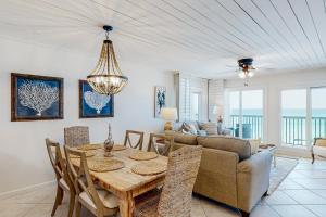 a living room with a table and a couch at Pinnacle Port C2-404 in Panama City Beach