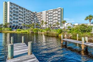 a dock in a body of water with a building at Pinnacle Port C2-404 in Panama City Beach
