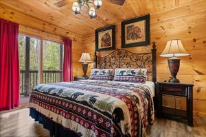 a bedroom with a bed in a log cabin at Mountain Laurel Lodge by American Patriot Getaways in Caton