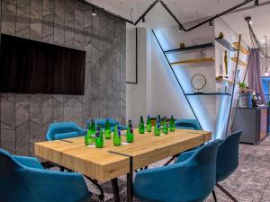 a conference room with a wooden table and blue chairs at Novotel Kraków Centrum in Kraków