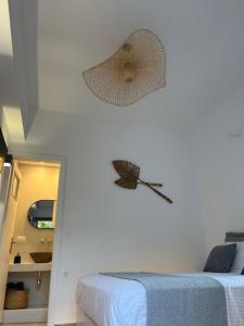 a room with a fan hanging on the wall at The Dream in Ios Chora +13 photos