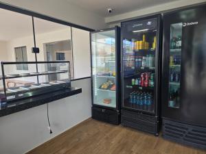 a large black refrigerator with drinks inside of it at Residencial Amora in Fortaleza