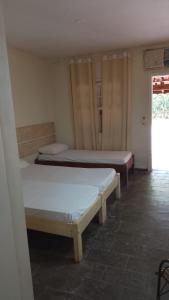 a room with two beds and a window at Reserva das Villas in Itatiba