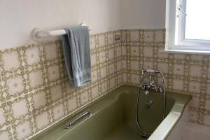a bath tub in a bathroom with a shower at 5 Bed House Sleeps 10 - 40 Minutes from Dublin in Summerhill +8 photos