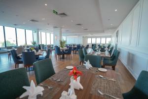 a dining room with tables and chairs and windows at Best Western Plus Jeddah Hotel Madinah Road in Jeddah