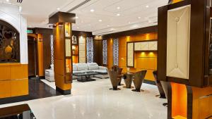 a lobby with chairs and a table in a building at رفا للشقق المخدومة-اقتصادي in Riyadh +44 photos