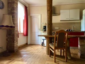 a kitchen with a table and a dining room at Eulenwohnung Apartment in Gommern