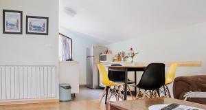 a living room with a table and yellow chairs at Green Zelina in Šulinec