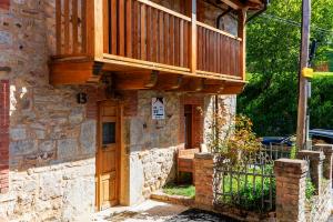 a building with a deck on top of it at La Casita de Verdiago in Verdiago