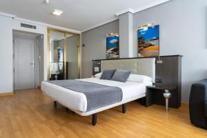 a bedroom with a large white bed in a room at Chateau La Roca in Sancibrián