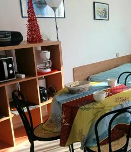 a room with a table and chairs and a bed at la Catalane in Vernet-les-Bains