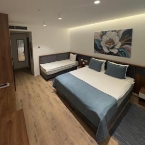 a bedroom with a large bed and a couch at Motel Krnjevo OAZA in Krnjevo