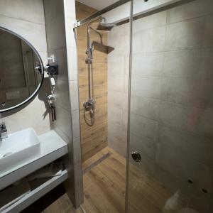 a bathroom with a shower and a sink at Motel Krnjevo OAZA in Krnjevo