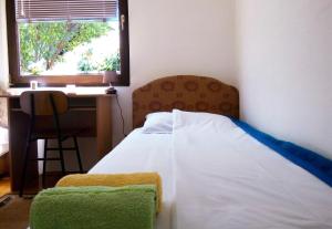 a bedroom with a bed and a desk and a window at Apartment Knez in Kolašin +23 photos