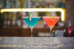 two martinis sitting on a counter in a bar at The Nest - Newly Renovated July 2025 in Kigali