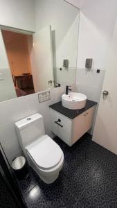 a bathroom with a white toilet and a sink at miralfores lighthouse in Lima +30 photos