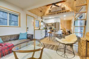 a living room with a couch and a table at Private Hot Tub! Cozy Crestline Cabin 1 Mi to Lake in Crestline +24 photos