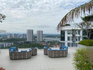 a group of wicker chairs sitting on a patio at Eclipse Residence in Cyberjaya