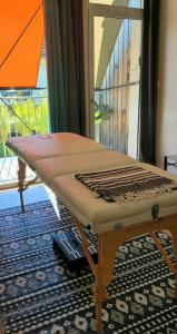 a mattress on a table in a room with a window at Le Cercle de Victoria in Bourges