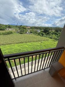a balcony with a view of a green field at Le Nomad Homestay in Batangas City
