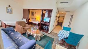 a living room with a couch and a table at Signature Apartment Berjaya Times square Bukit Bintang in Kuala Lumpur