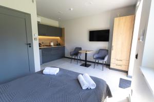 a bedroom with a bed with two towels on it at ERNESTÓWKA - Hotel in Czarna +8 photos