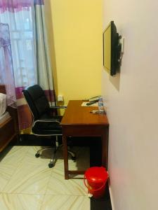 an office with a desk and a chair and a television at Doreen Executive Inn in Morogoro +1 photo