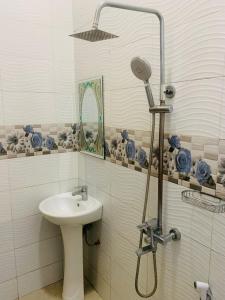 a bathroom with a sink and a shower at Doreen Executive Inn in Morogoro