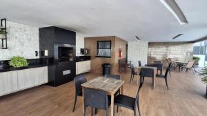 a kitchen and dining room with a table and chairs at Apartamento COP30 de Alto Padrão in Belém