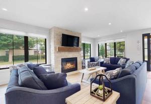 a living room with blue couches and a fireplace at expERIEnce in South Haven