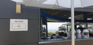a sign on the side of a building with a sun roof at La Caleta Seaside Villa With Pool in Adeje