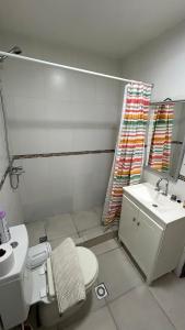 a small bathroom with a toilet and a sink at Casa Amplia in Río Grande