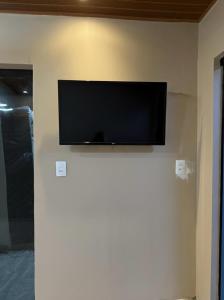 a flat screen tv on a wall in a room at Lar Bernardes COP 30 in Belém