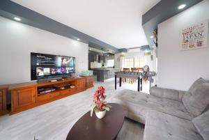 ナ・ジョムティエンにある5 bedroom pool villa quiet beachのソファ、テレビ、テーブルのあるリビングルーム