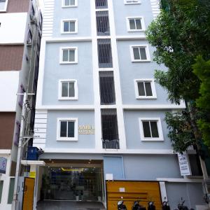 a white building with a store in front of it at Axon Business Hotel Kondapur HITEC City Hyderabad in Kondapur