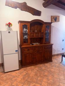 a kitchen with a wooden cabinet and a refrigerator at La Dimora in Formello